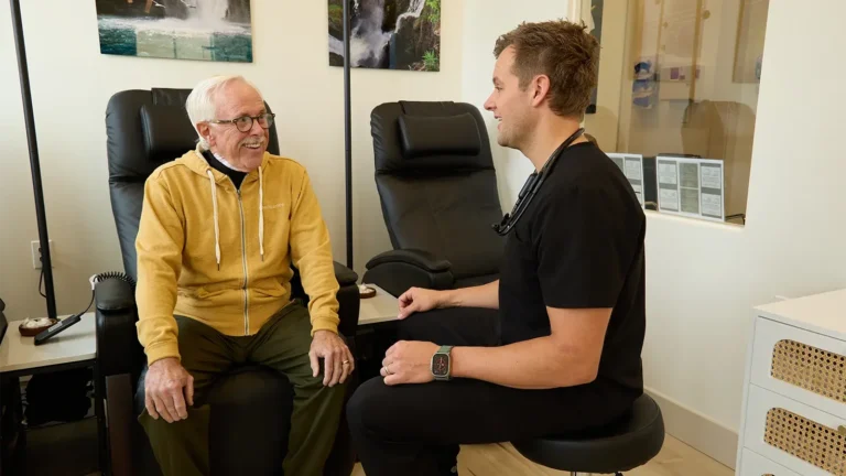 Older male client consulting with younger male clinician