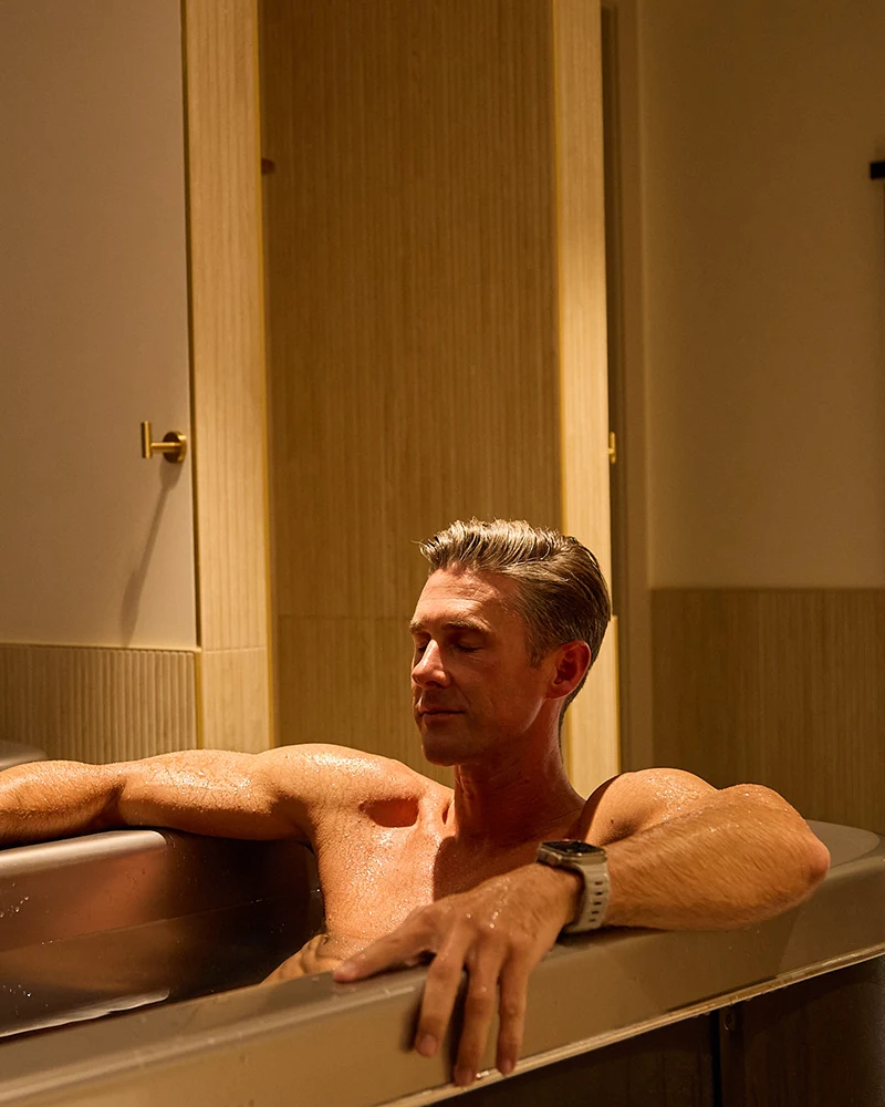 A man relaxes in a cold plunge tub