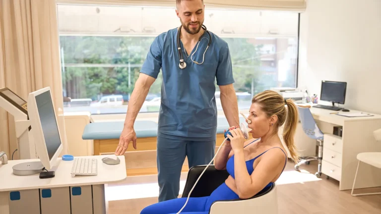 Male dietologist watching woman taking resting metabolic rate test